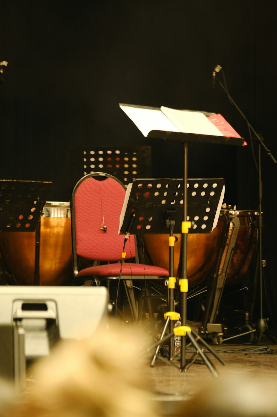 Professional television studio with cameras on tripods and warm lighting rig