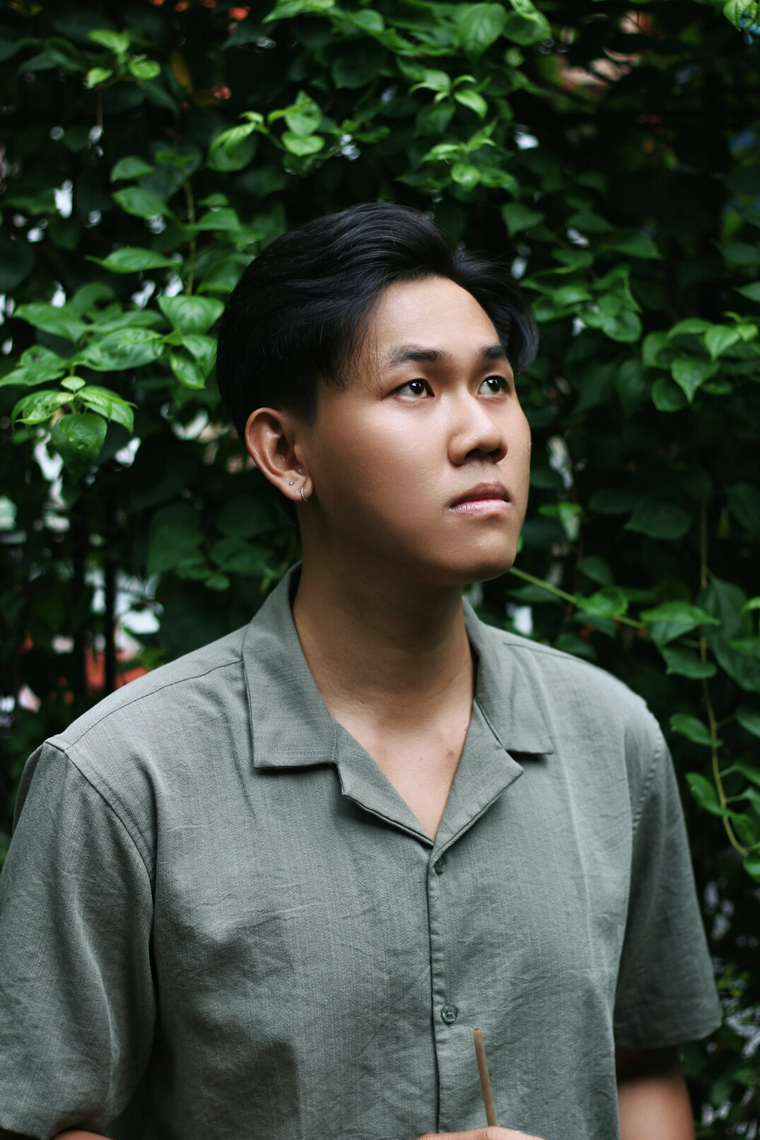Portrait of a young man with short hair wearing a shirt